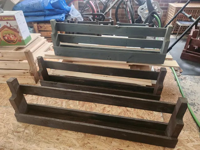Three wall shelves in mixed finishes in the workshop
